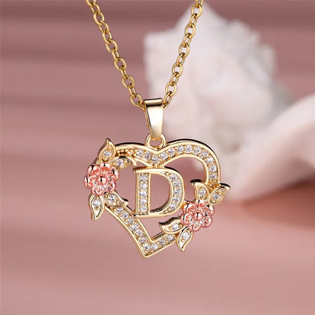 The letter D in a heart pendant necklace with rhinestones