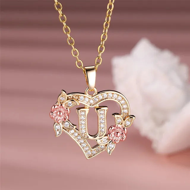The letter U in a heart pendant necklace with rhinestones