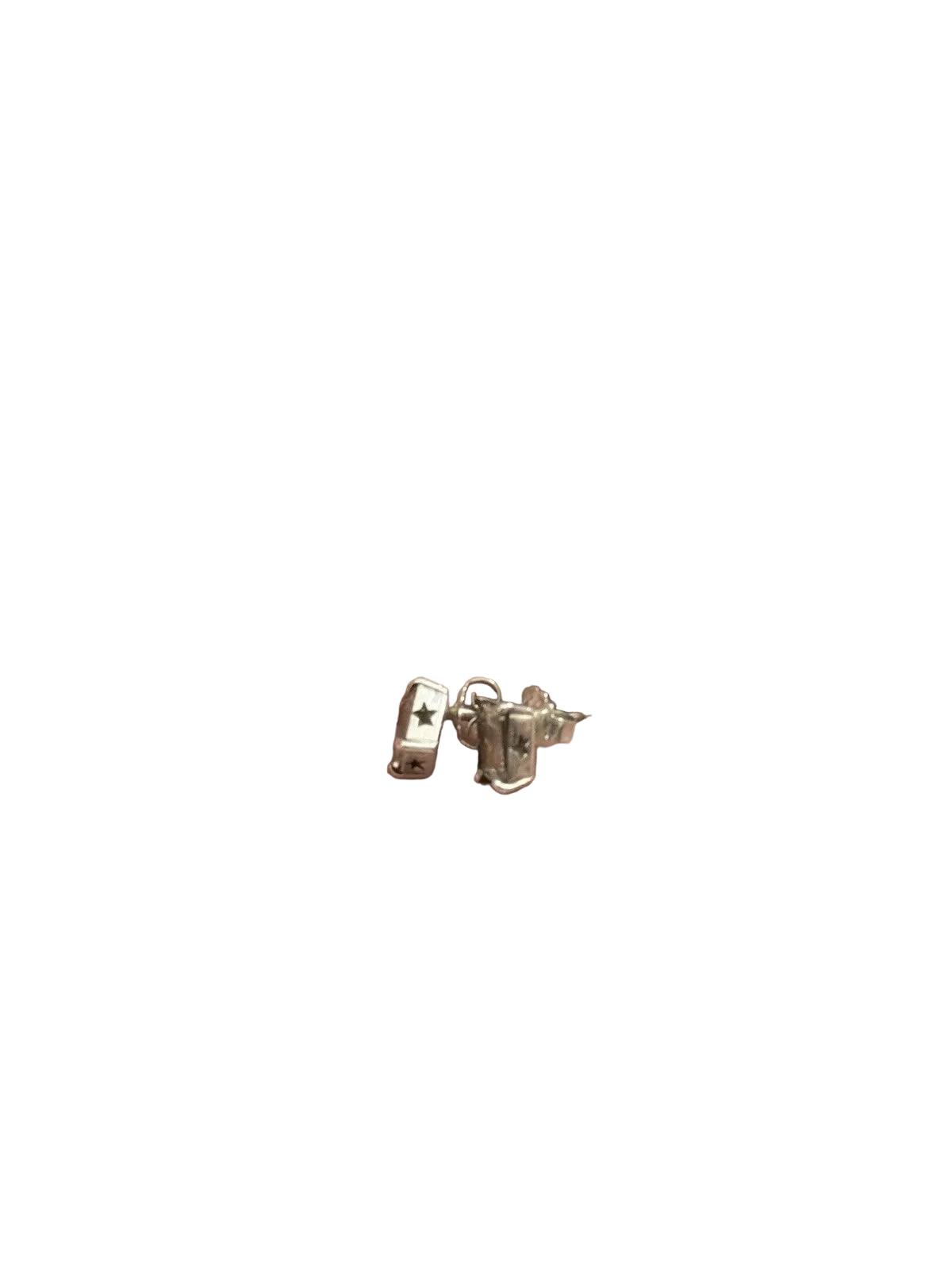 A pair of small silver stud earrings with stars cut out of the bezels shown on a plain clear background.