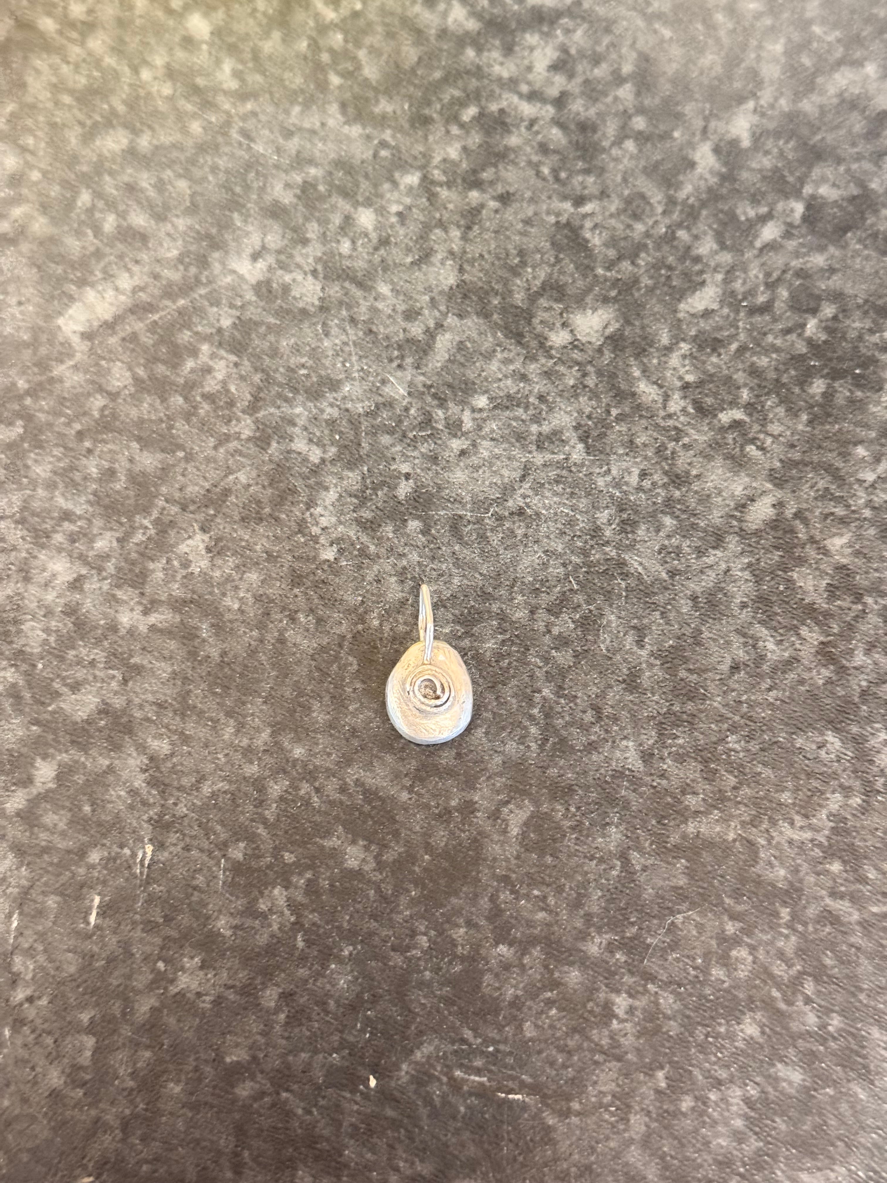 A small rose pendant in sterling silver for use on its own or with ashes for memorial jewellery