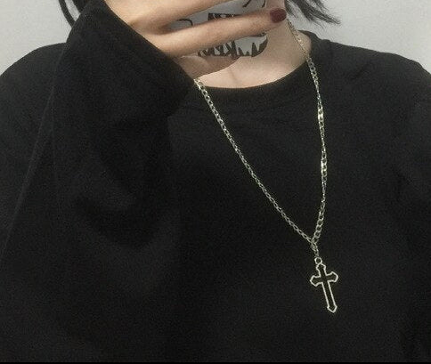A teenager in Gothic style holding her mobile phone and wearing the necklace