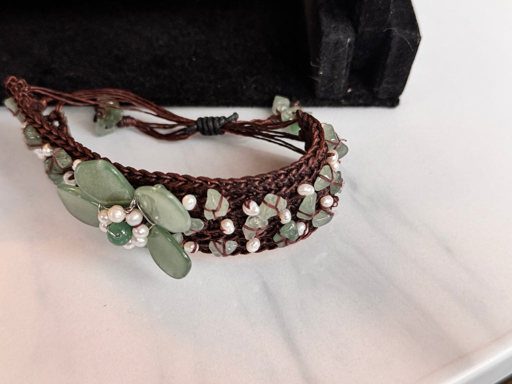 Detail of hand-woven green jade and seed pearl bracelet band