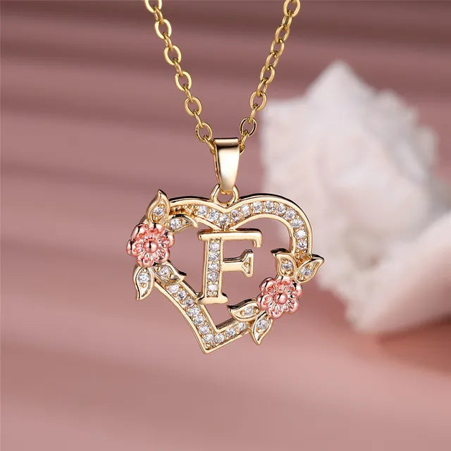 The letter F in a heart pendant necklace with rhinestones