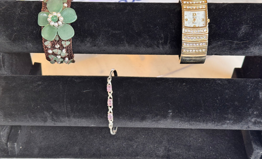 This image displays 2 bracelets and a watch. This product is the Green jade and white seed pearls on a brown woven wide friendship band. Very Boho and Very beautiful.