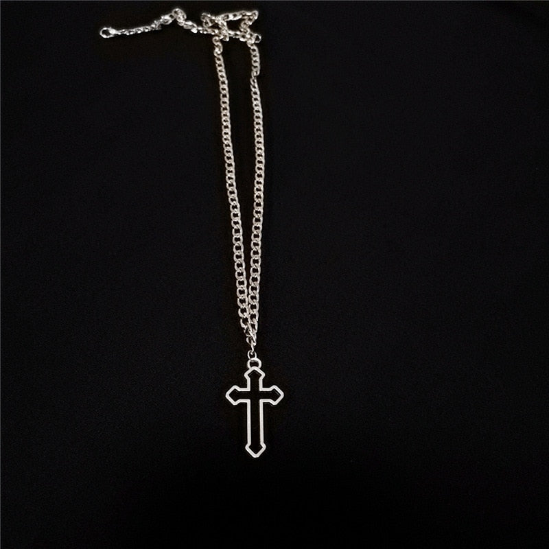 This image displays the chain on a black background and the silver tone cross and curb chain really stand out.
