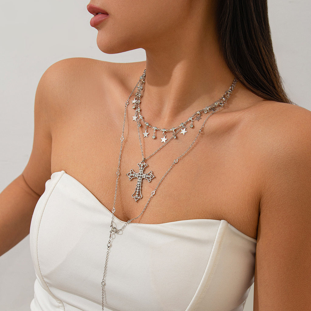 Vintage inspired silver-tone layered necklace. 1 lariat chain one collar length with stars and ball beads and one princess with a cross pendant.