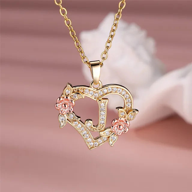 The letter J in a heart pendant necklace with rhinestones