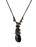 A dark bronze chain necklace featuring a beaded pendant with a large teardrop-shaped dark blue/black stone and smaller dark gray and brown beads, shown against a plain white background. Vintage Iridescent Lariat Necklace