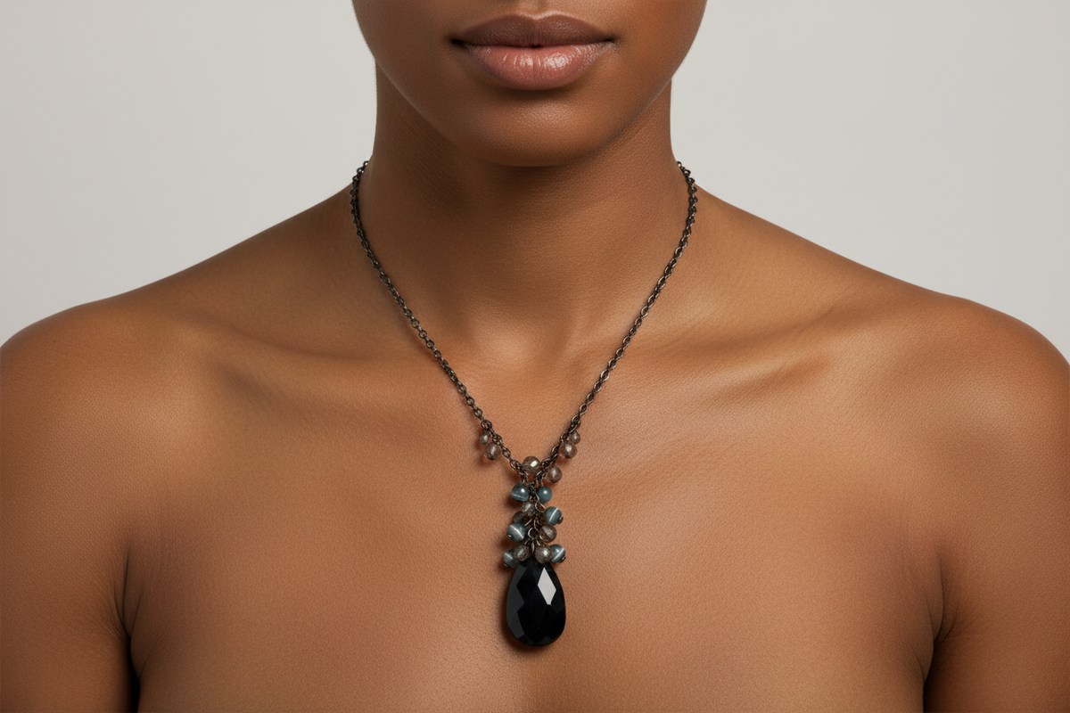 The Vintage lariat style necklace as it would have been worn originally. This is an Ai photo of the necklace. The Teardrop is more iridescent and a purple black but gives an idea of how it looks