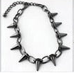 A spiked chain necklace in gun metal black with sharp metallic spikes, shown against a plain white background.