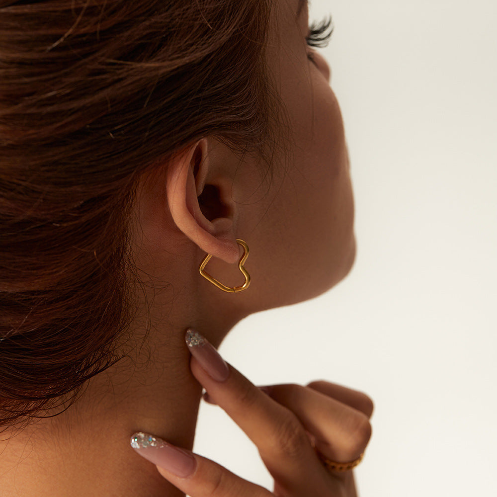 Another view of the heart earrings on a person. The point is at the back of the ear. This is the golden pair.