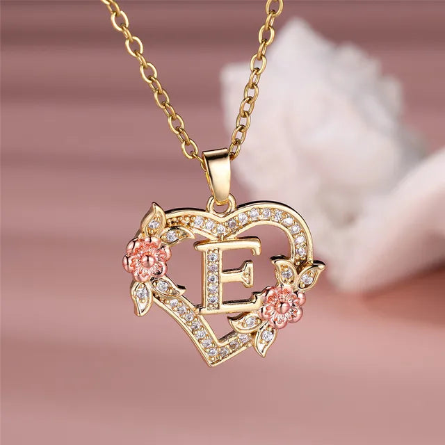 The letter E in a heart pendant necklace with rhinestones