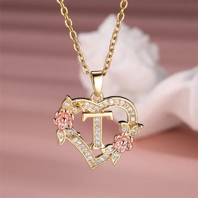 The letter T in a heart pendant necklace with rhinestones