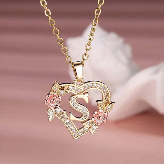 The letter S in a heart pendant necklace with rhinestones