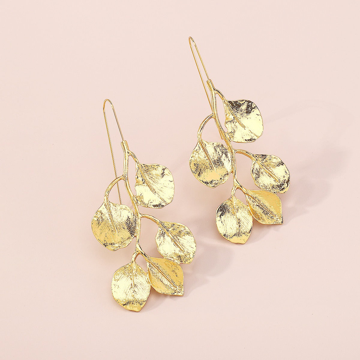 Vintage style Leafy earrings from a different angle shot. Again on a cream background displaying the long hook for pierced ears.