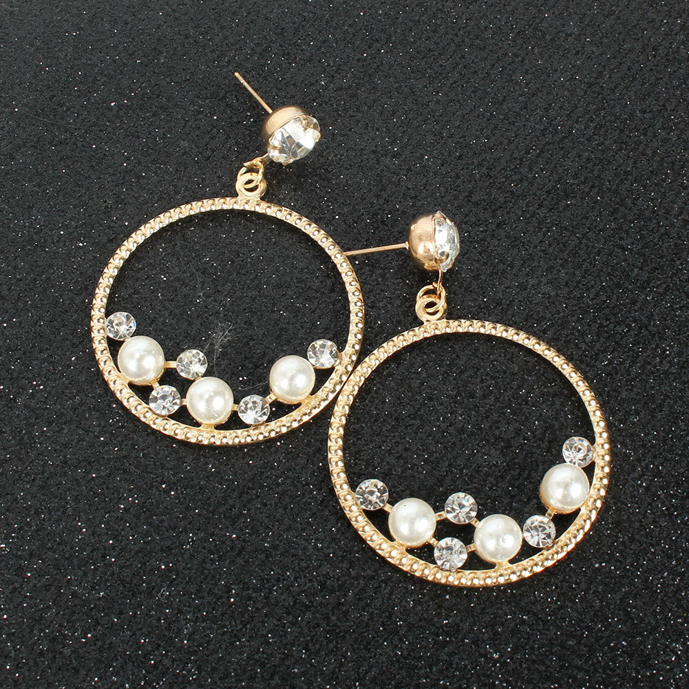 The golden decorative hoops displayed on the black glitter fabric in a different position