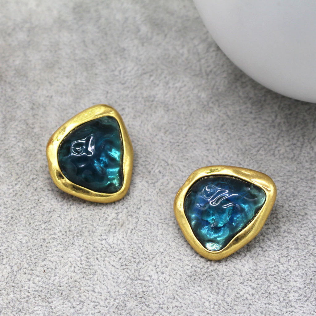 This image shows the earrings against a Grey background. The Centre reminds me of a deep Sea Green /blue