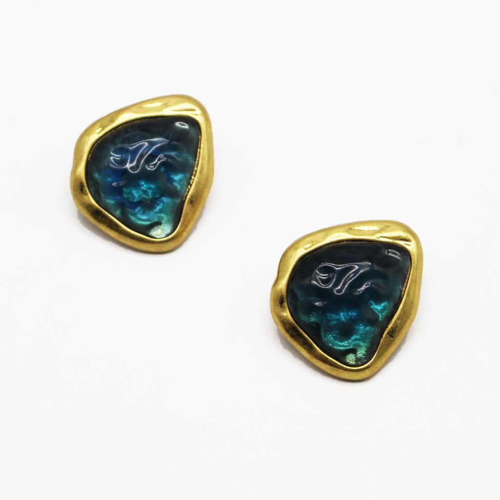 The Bezel set abstract clip on earrings against a white background.