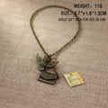An antique bronze owl and letter envelope pendant necklace on a textured hessian background, with product specifications text overlay in the top right. Weight 11gms, 2.7 x 1.8 x 1.3 cm