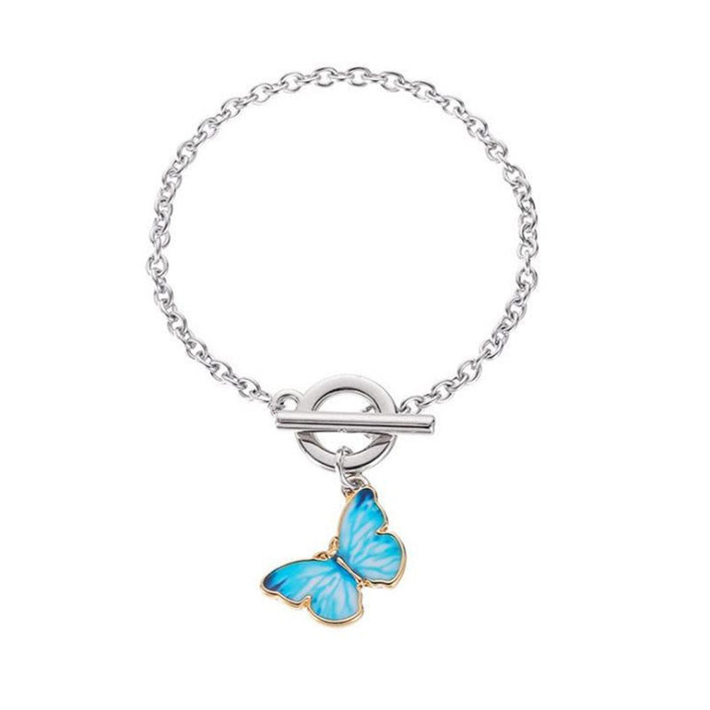 This is the turquoise butterfly with golden edging on the bracelet in silver tone on a white background. 