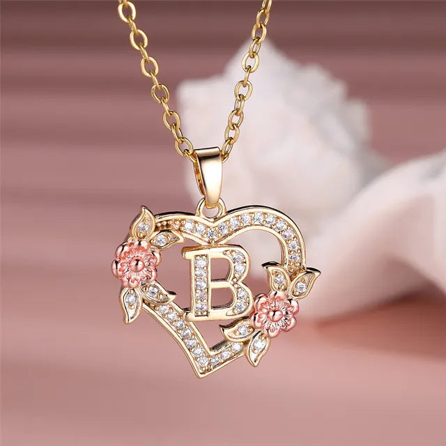 The letter B in a heart pendant necklace with rhinestones