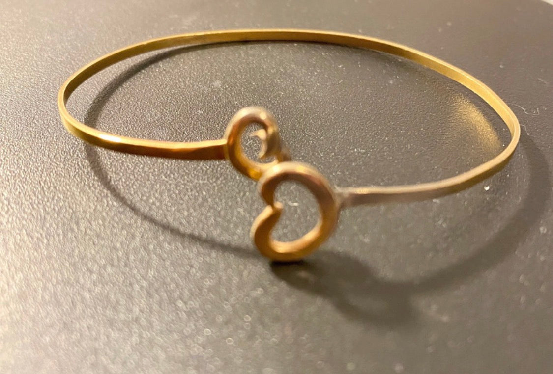 Close-up of handmade gold plated butterfly bangle showing partial two-tone plating detail