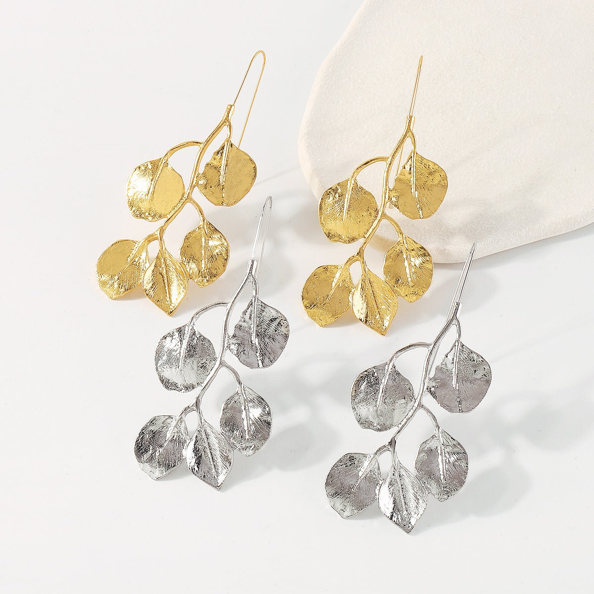 Both Gold-tone & silver-tone Leafy Earring in a vintage style on a white background