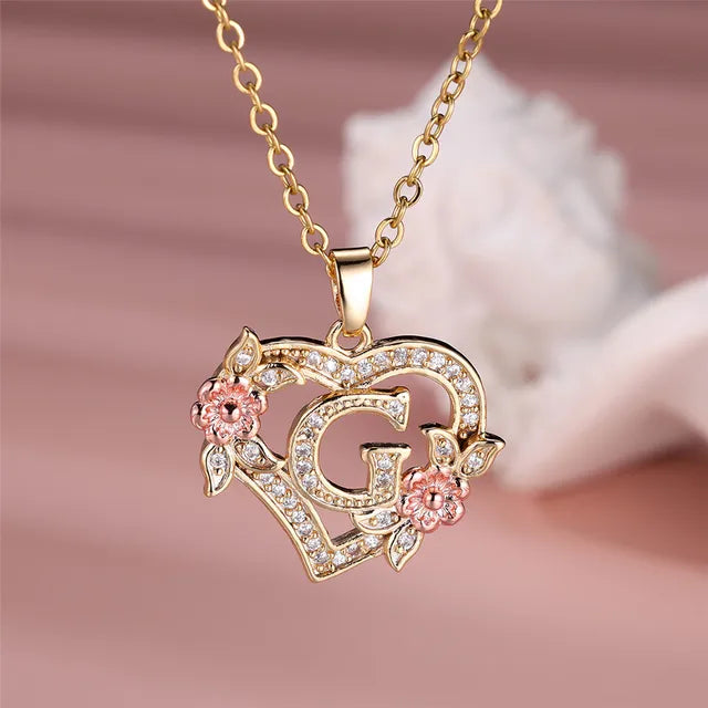 The letter G in a heart pendant necklace with rhinestones