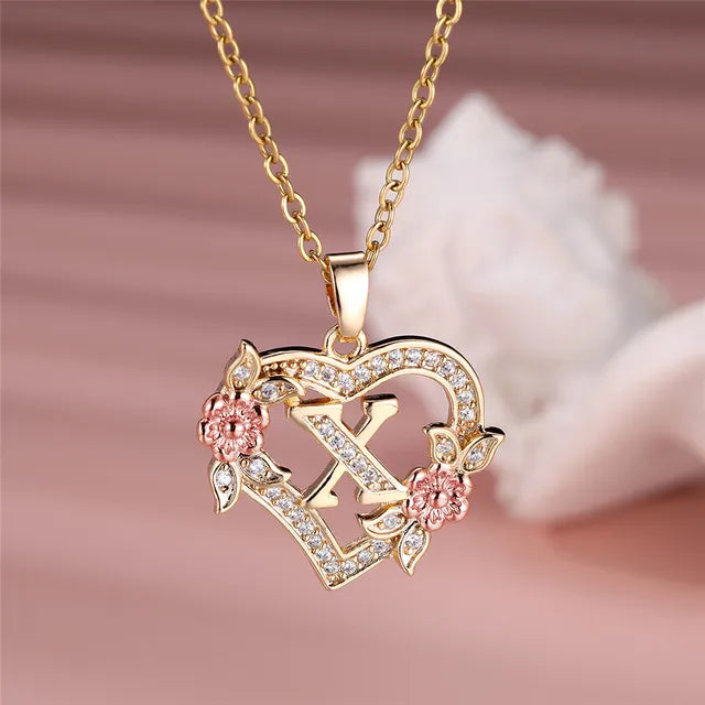 The letter X in a heart pendant necklace with rhinestones