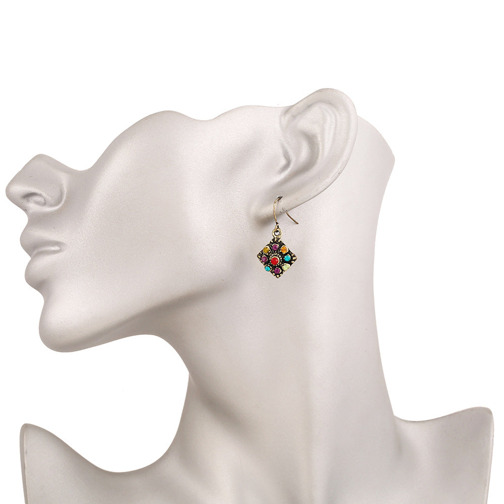 An Amazing boho design incorporating semi precious style stones n a geometric design with a white background on  jewellery model
