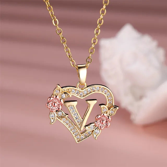 The letter V in a heart pendant necklace with rhinestones
