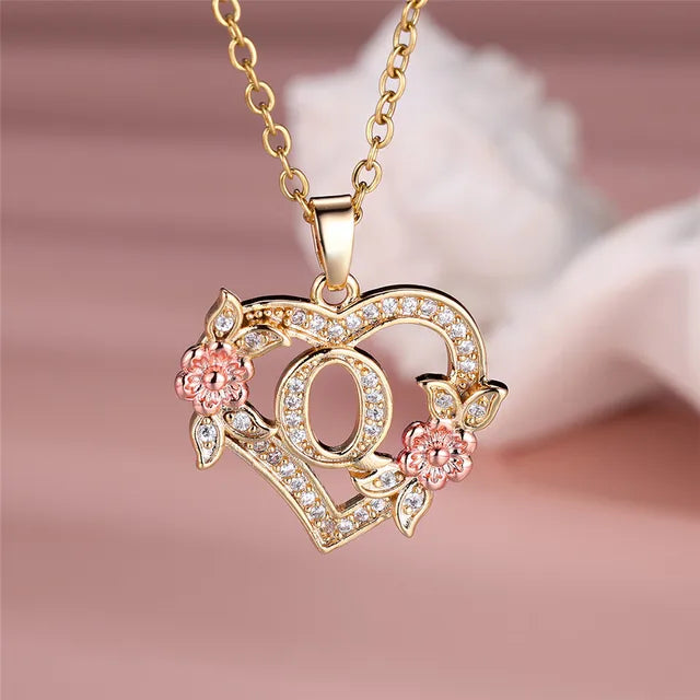 The letter Q in a heart pendant necklace with rhinestones