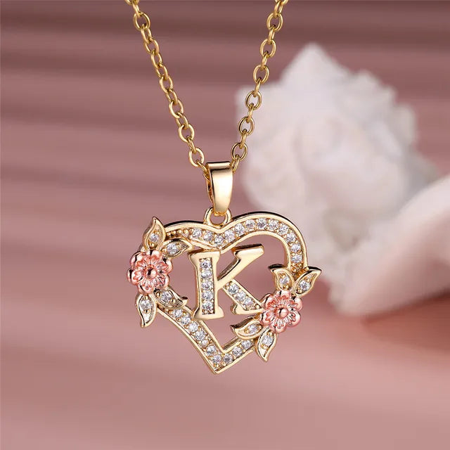 The letter K in a heart pendant necklace with rhinestones