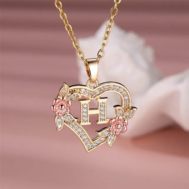 The letter H in a heart pendant necklace with rhinestones