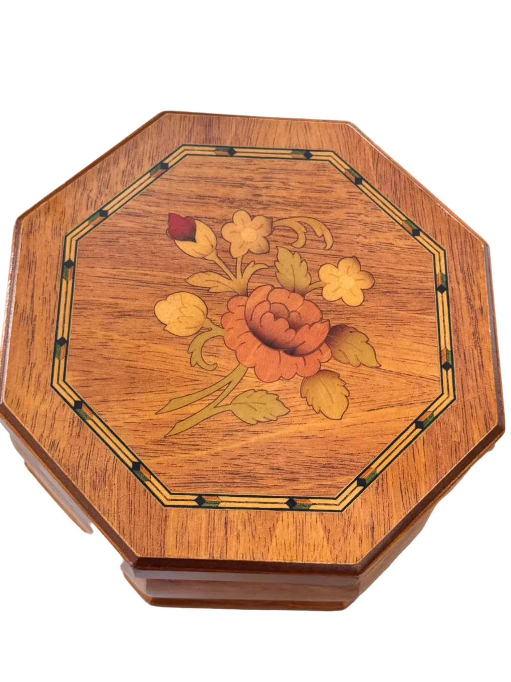 An octagonal wooden jewellery box with a floral inlay design on the lid, featuring a central rose and yellow flowers with green leaves, set against a plain white background.