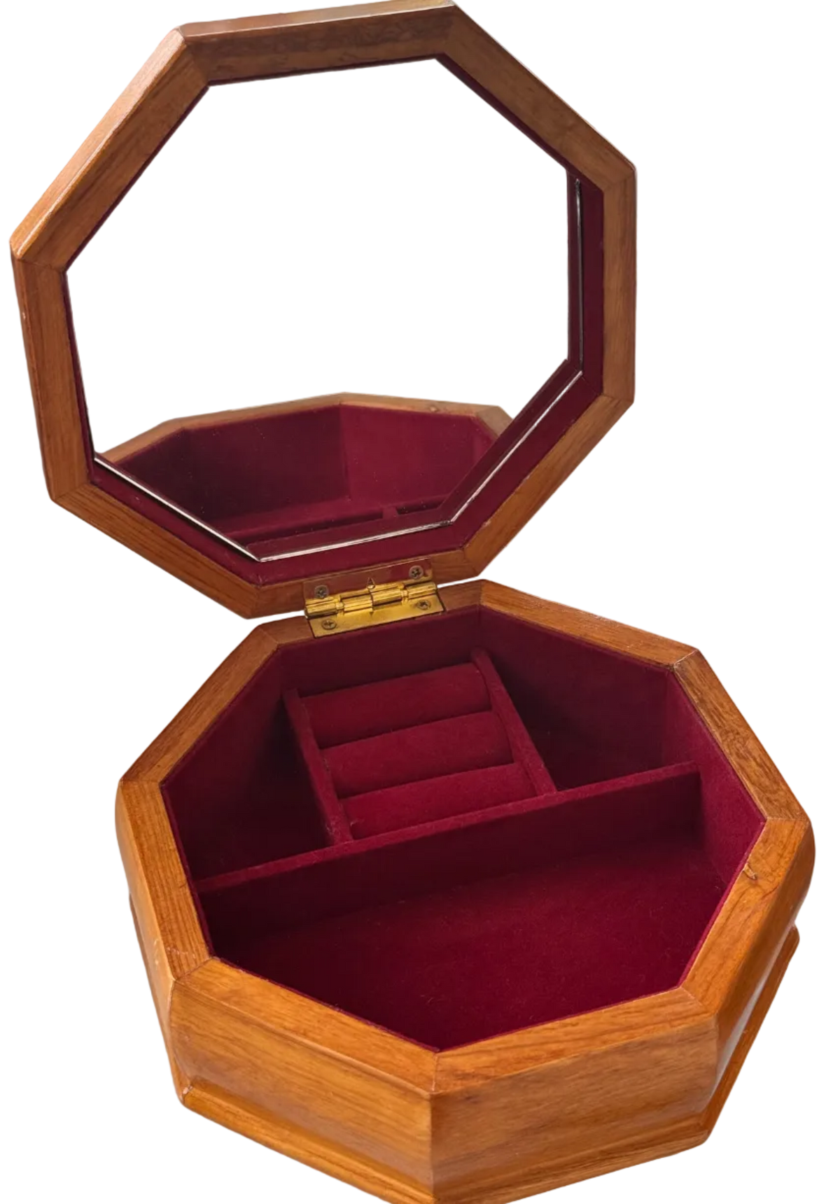 An octagonal wooden jewelry box with an open lid featuring an integrated mirror, lined with deep red velvet interior and divided into small compartments.