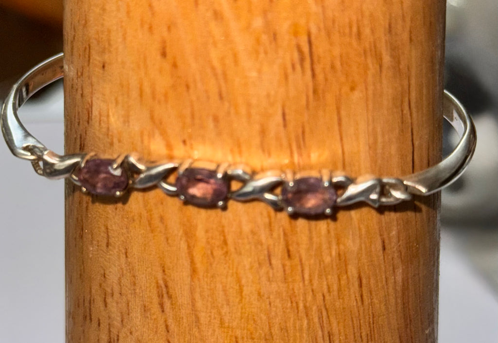 A close up of the sterling silver bracelet with 3 purple stones