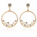 Golden Drop hoops with a stud closure for pierced ears.  A decorative hoop wire with a Clear rhinestone stud at the top and the hoops decorated with faux pearls and clear stones on a white background