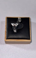 A sterling silver s925 abstract sea snake sculptural ring displayed on a black cushion inside a square wooden presentation box, photographed against a light gray background.