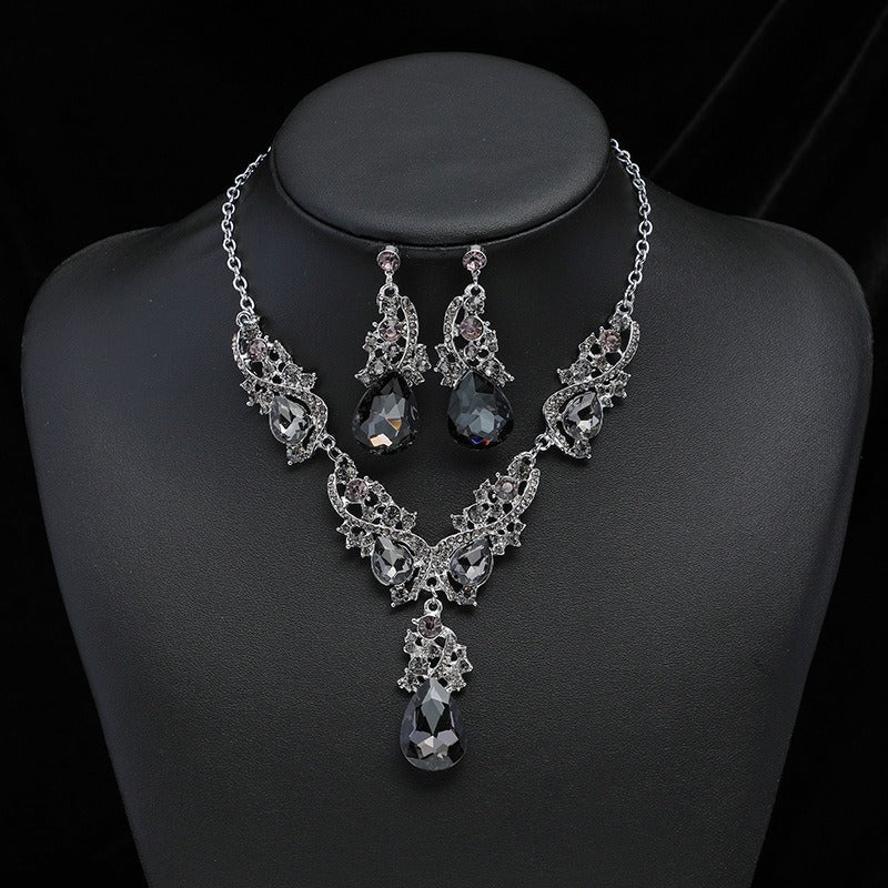 This is the black style faux Gemstone 2 piece vintage style jewellery set of earrings and a necklace on a charcoal bust. Stunning choice