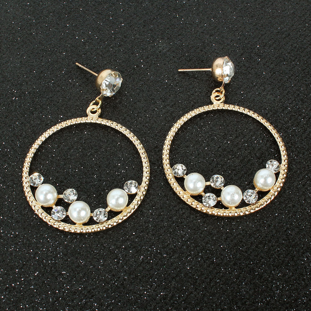 This image gives a different angle shot of the earring hoops set on a black glitter fabric and displays the posts for pierced ears