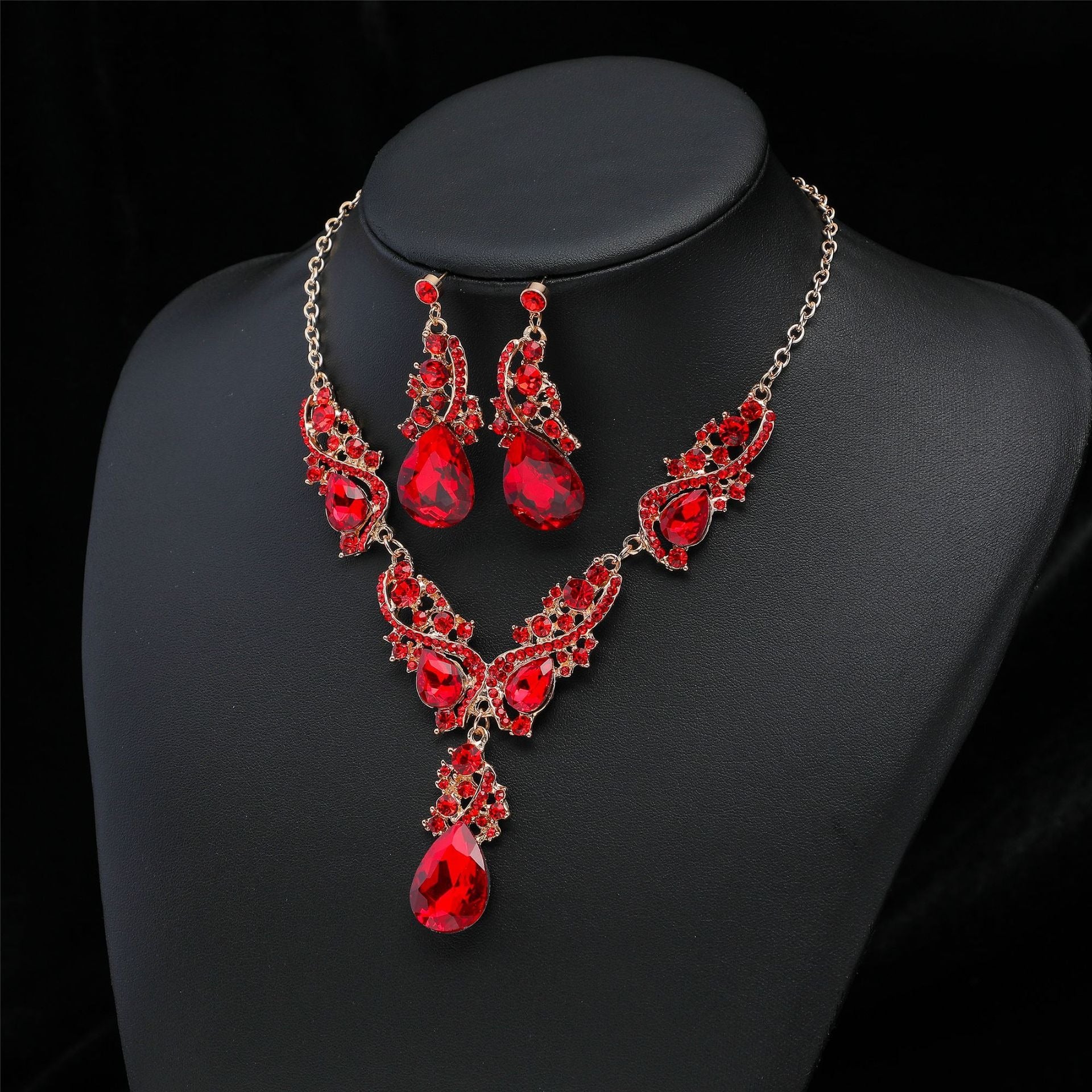 This is the red faux gemstone set with a view slightly from the side on a black mannequin bust