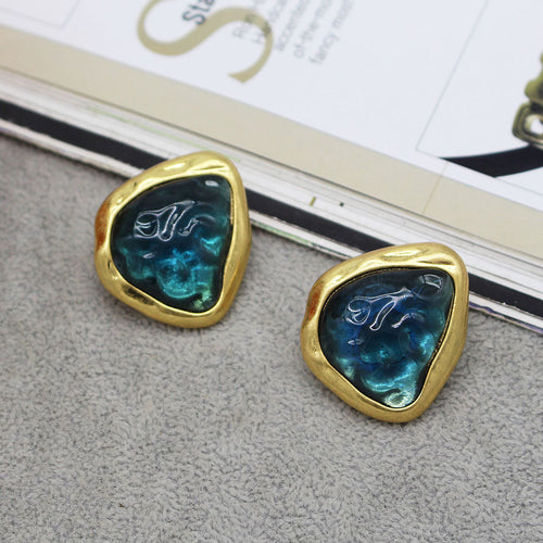 Abstract Gold-tone earrings in  gold-tone bezel setting. An abstract Triangular Shape with A sea looking centre. Very stylish and Elegant
