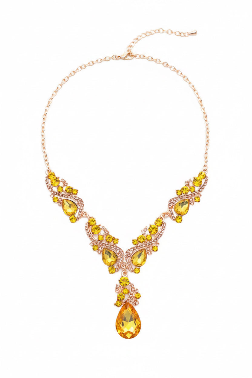 Golden necklace with yellow Citrine colour faux gemstones on a white background. 