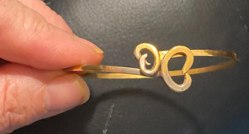 Handmade 24ct gold plated butterfly bangle showing coin knot terminals hooked together to form butterfly shape